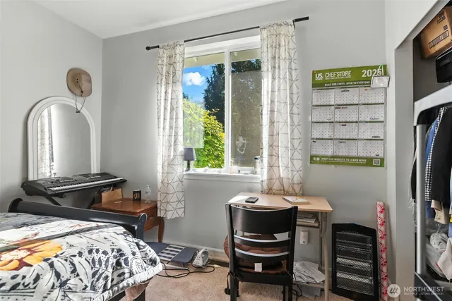 a bedroom with a bed and a mirror