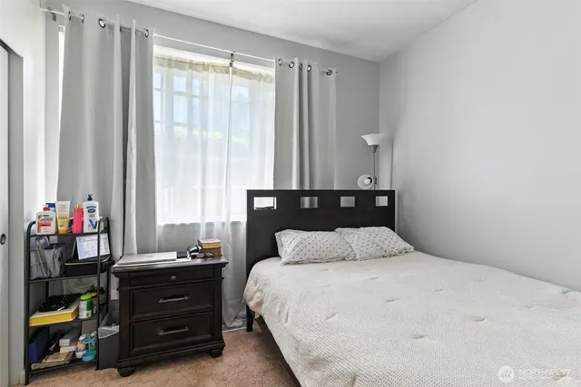 a bedroom with a bed and a closet