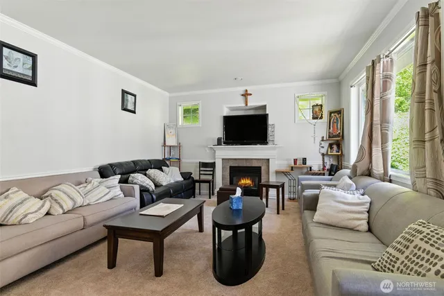 a living room with furniture a large window and a fireplace