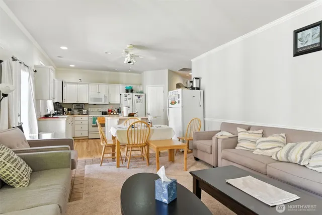 a living room with lots of furniture and kitchen view