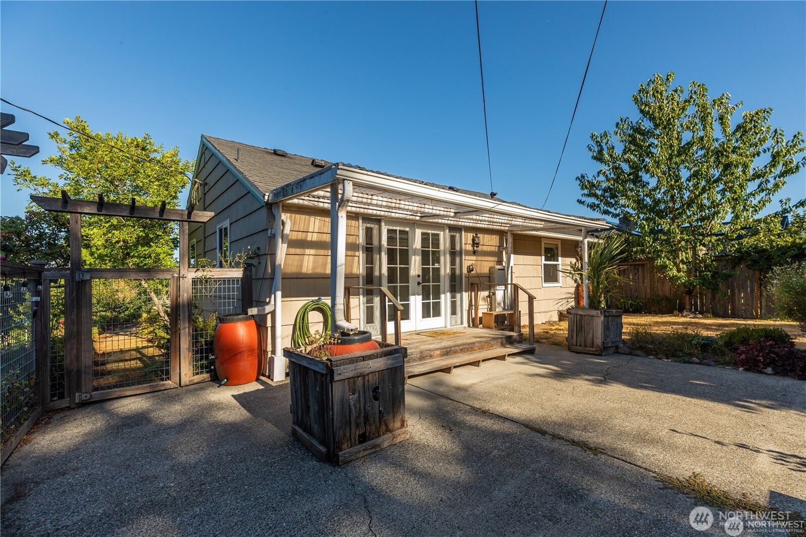8601 36th Avenue Southwest Seattle, WA 98126 - Photo 26 of 28 a view of a house with backyard sitting area and garden