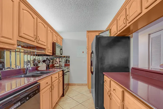 a kitchen with stainless steel appliances a refrigerator and a sink
