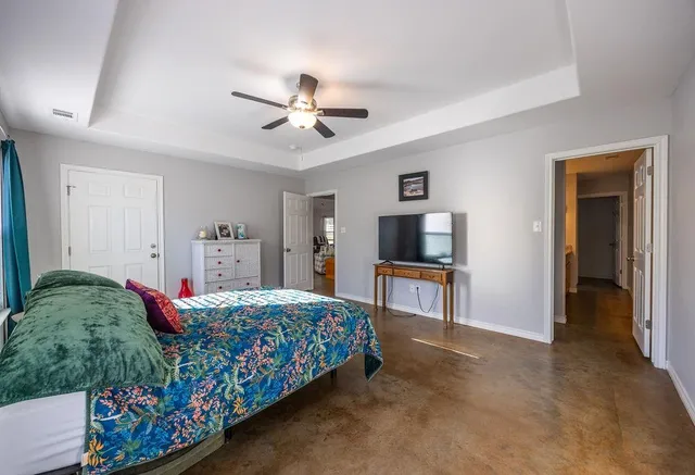 a bedroom with a bed and a flat screen tv