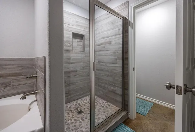 a bathroom with a glass shower door