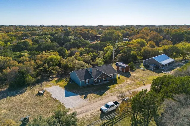 an aerial view of residential houses with outdoor space
