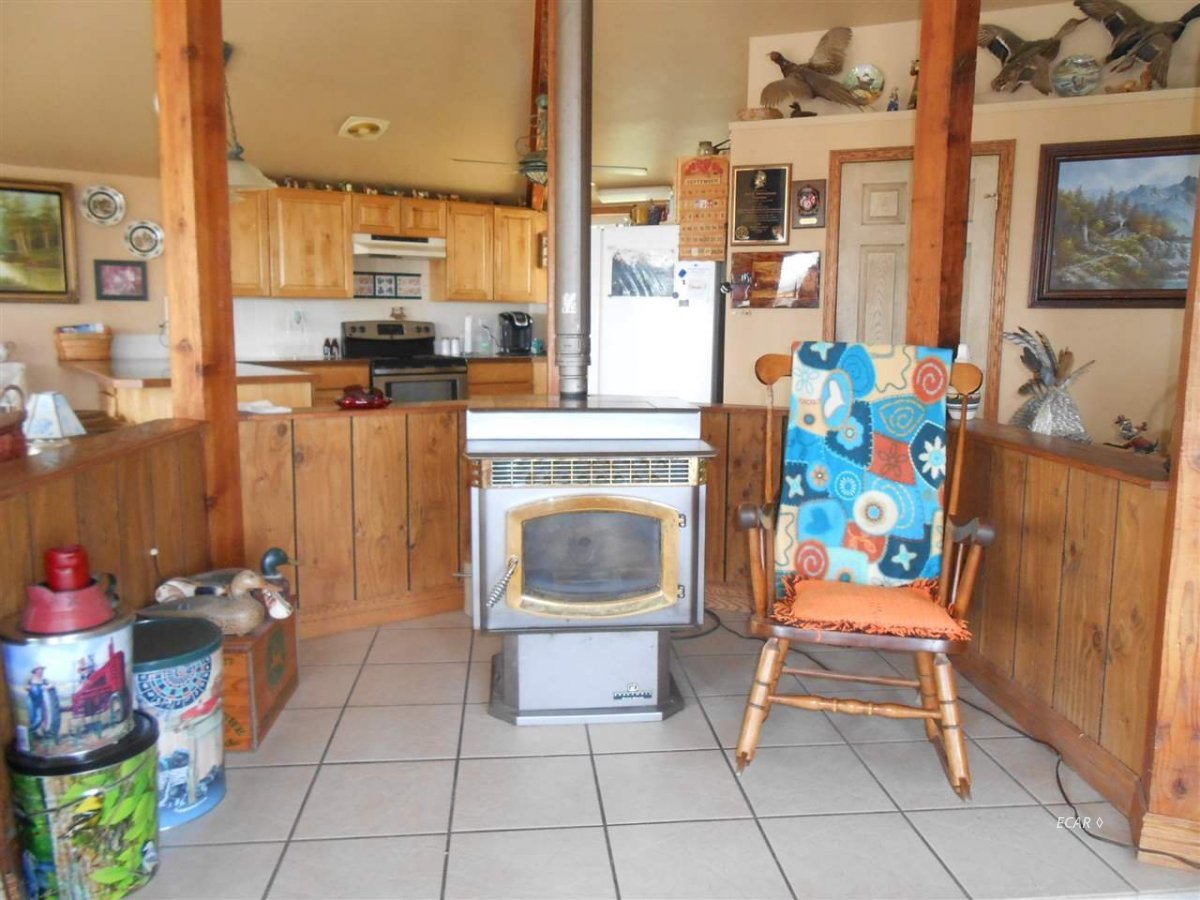 9039 Ruby Valley Road Spring Creek, NV 89815 - Photo 29 of 47 a dining room with furniture and a fireplace