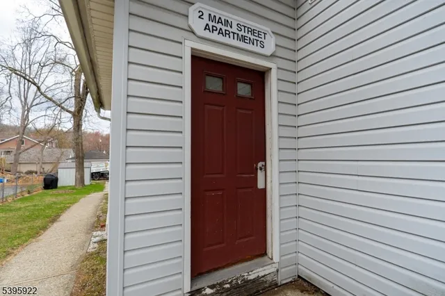 a view of a house with a door and wooden walls