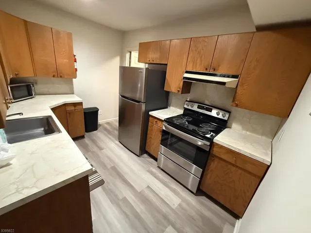 a kitchen with wooden cabinets and a refrigerator
