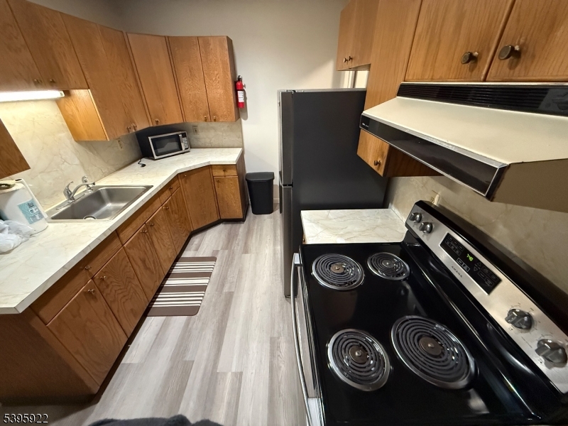 2 Main Street, Unit 1 Branchville, NJ 07826 - Photo 8 of 16 a kitchen with a stove and a refrigerator