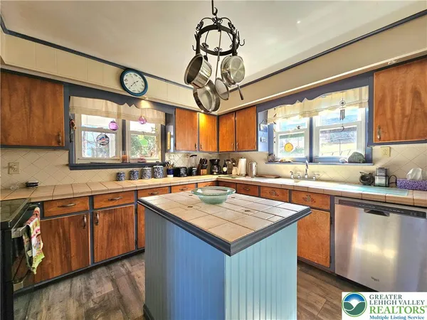 a kitchen with a large island in the center windows and a sink