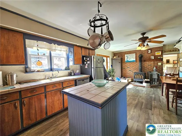 a kitchen with a counter space a sink appliances and cabinets