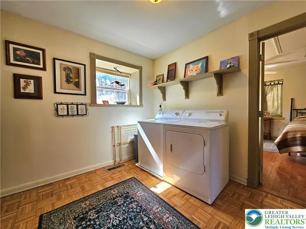 a utility room with a sink and a mirror