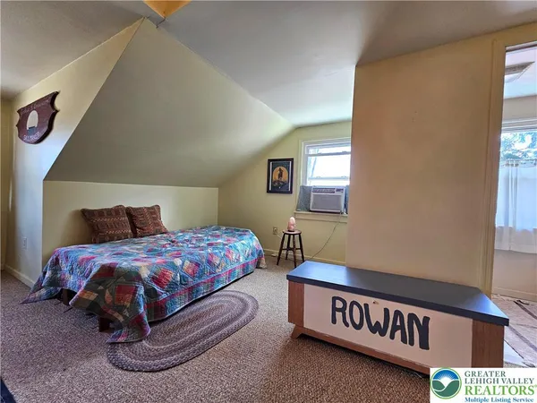 a bedroom with a bed and window