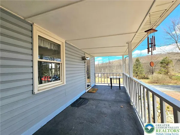 a view of a porch with wooden floor and outdoor space