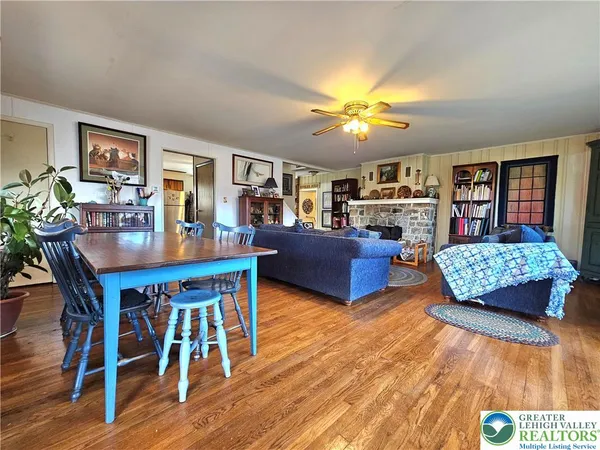 a living room with fireplace furniture and a wooden floor