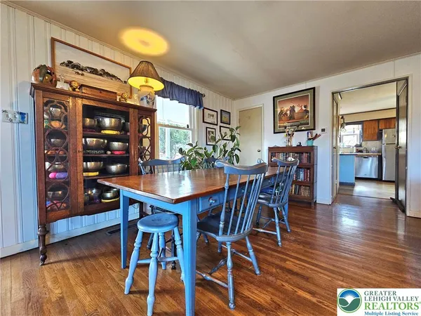a view of a dining room with furniture and wooden floor