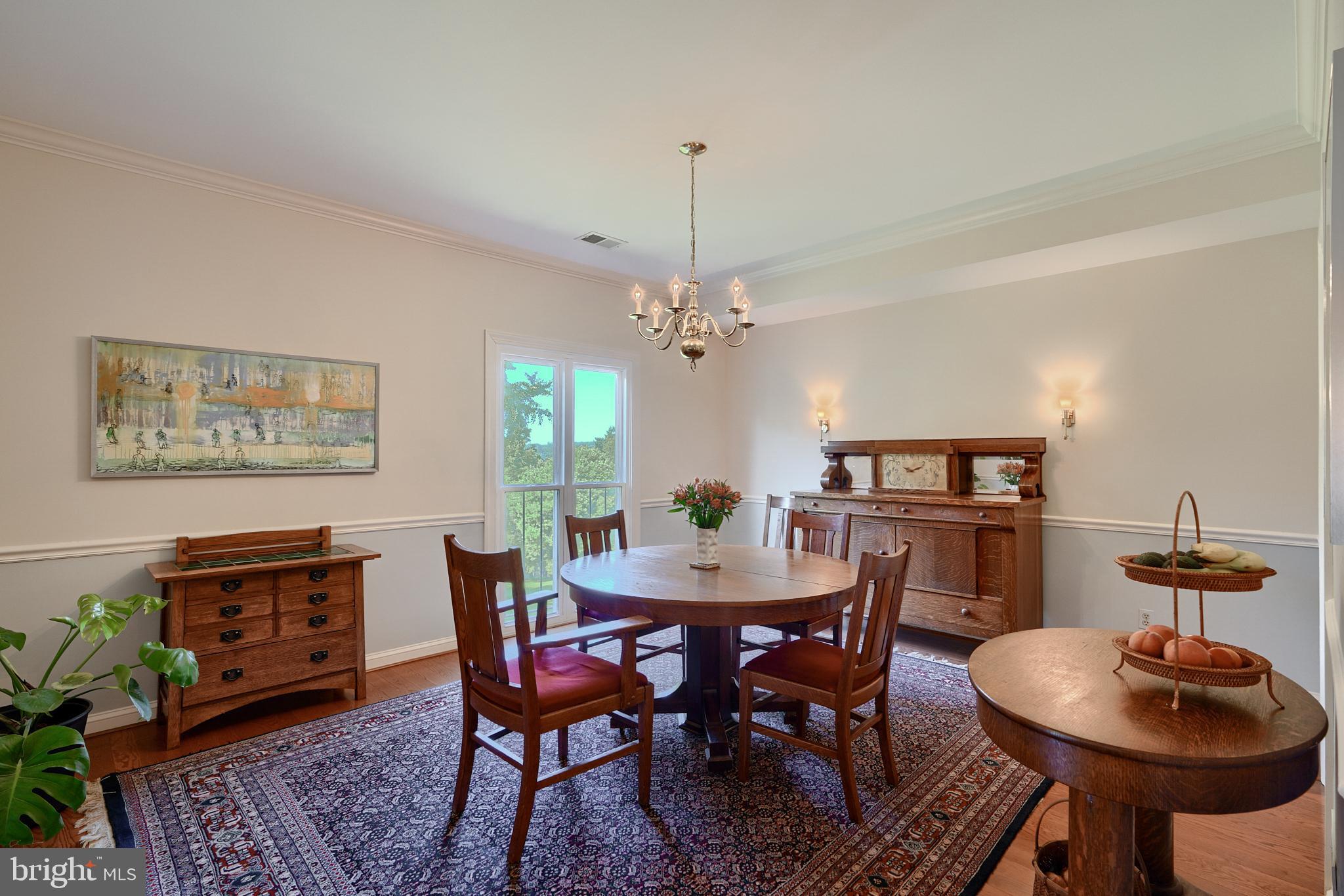 7 Devon Hill Road, Unit A6 Baltimore, MD 21210 - Photo 14 of 61 a dining room with furniture a rug and a chandelier