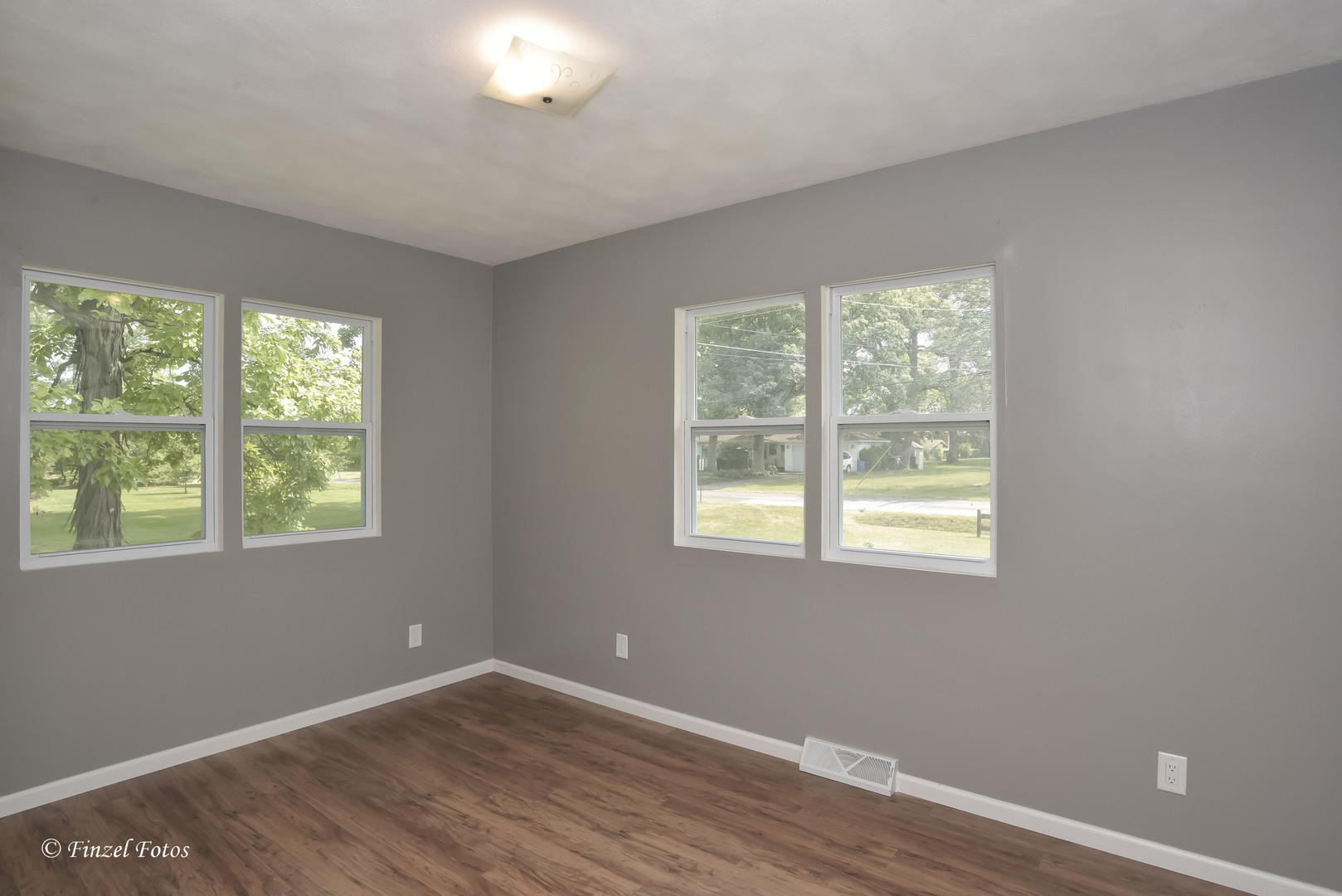 1009 Hickory Road Woodstock, IL 60098 - Photo 11 of 18 a view of an empty room with wooden floor and a window