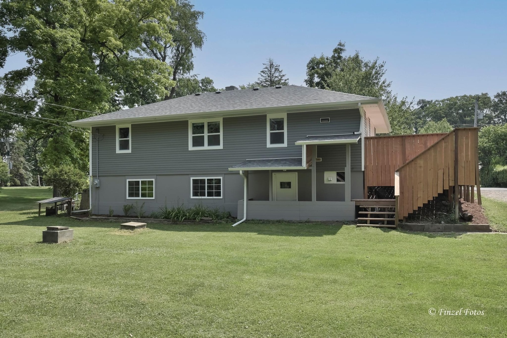 1009 Hickory Road Woodstock, IL 60098 - Photo 17 of 18 a backyard of a house with barbeque oven and table and chairs