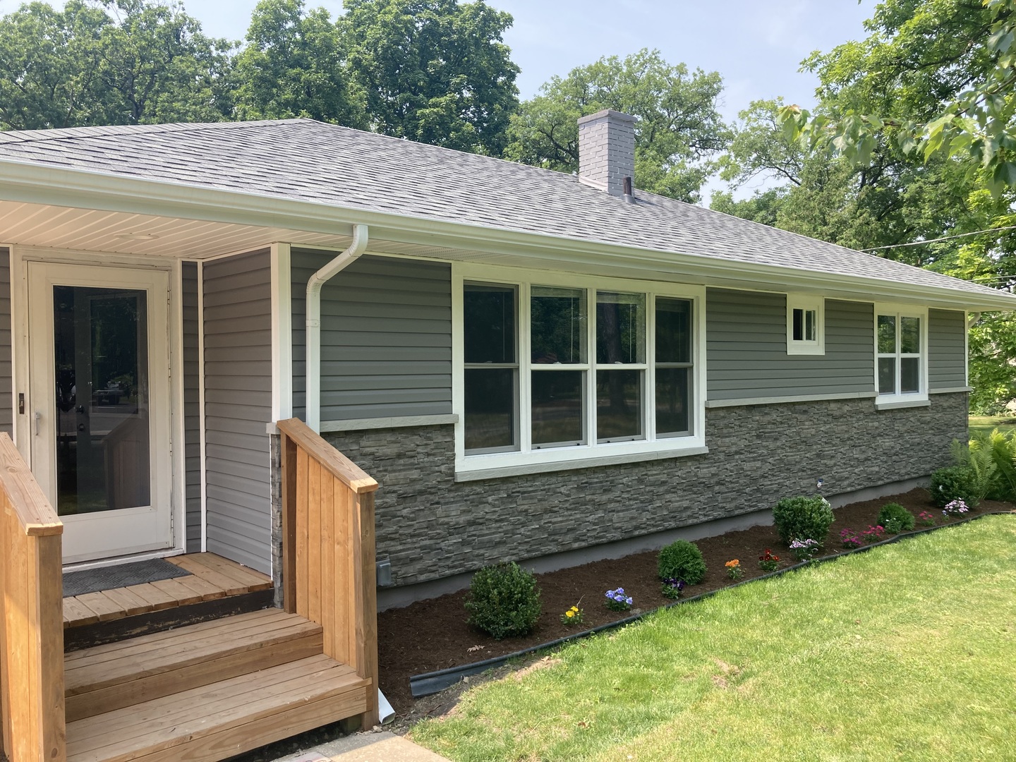 1009 Hickory Road Woodstock, IL 60098 - Photo 2 of 18 a front view of a house with a yard