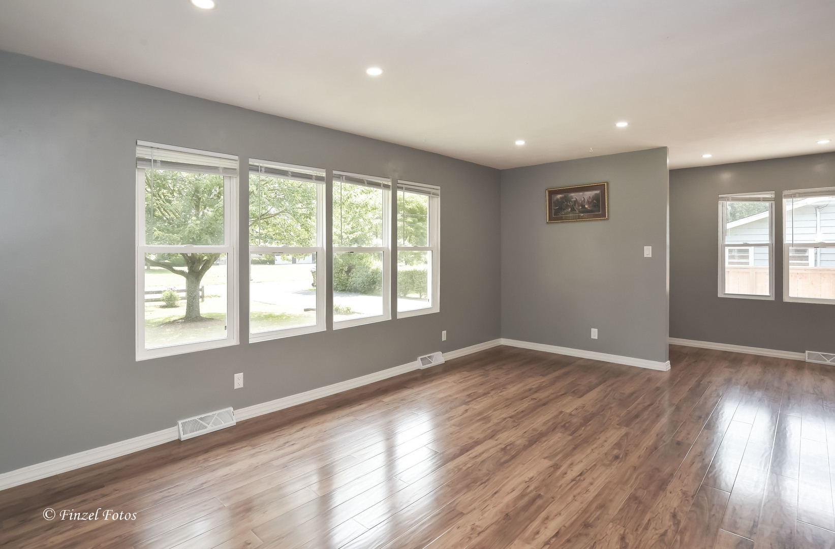 1009 Hickory Road Woodstock, IL 60098 - Photo 5 of 18 a view of an empty room with wooden floor and a window