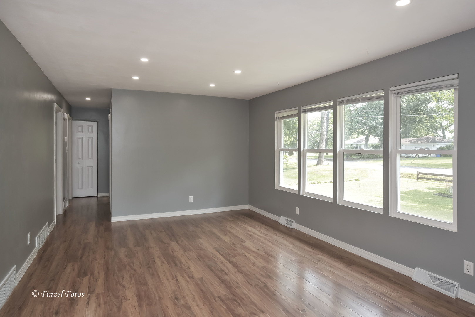 1009 Hickory Road Woodstock, IL 60098 - Photo 7 of 18 a view of empty room with wooden floor and fan