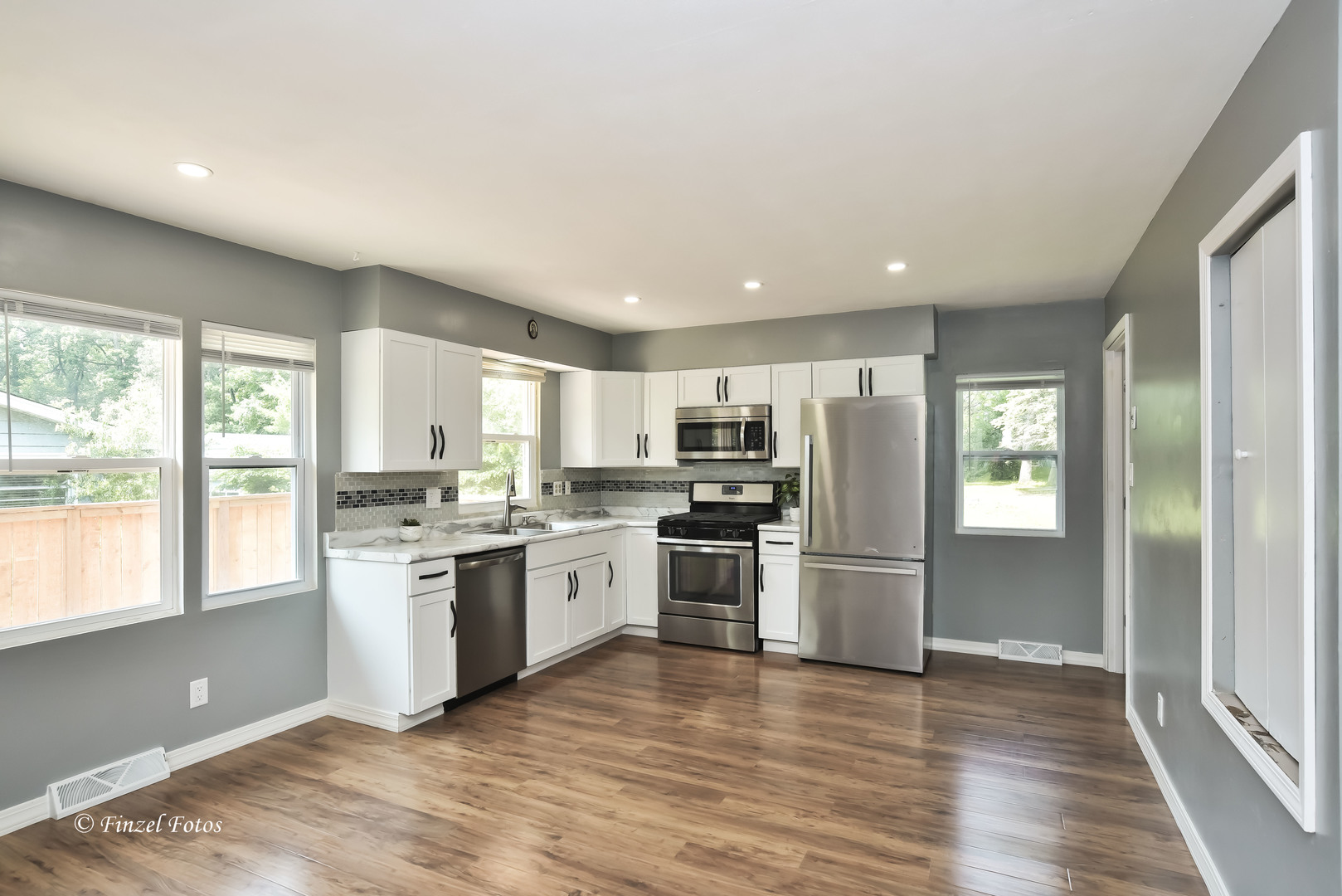 1009 Hickory Road Woodstock, IL 60098 - Photo 8 of 18 a kitchen with stainless steel appliances granite countertop a refrigerator and a stove top oven