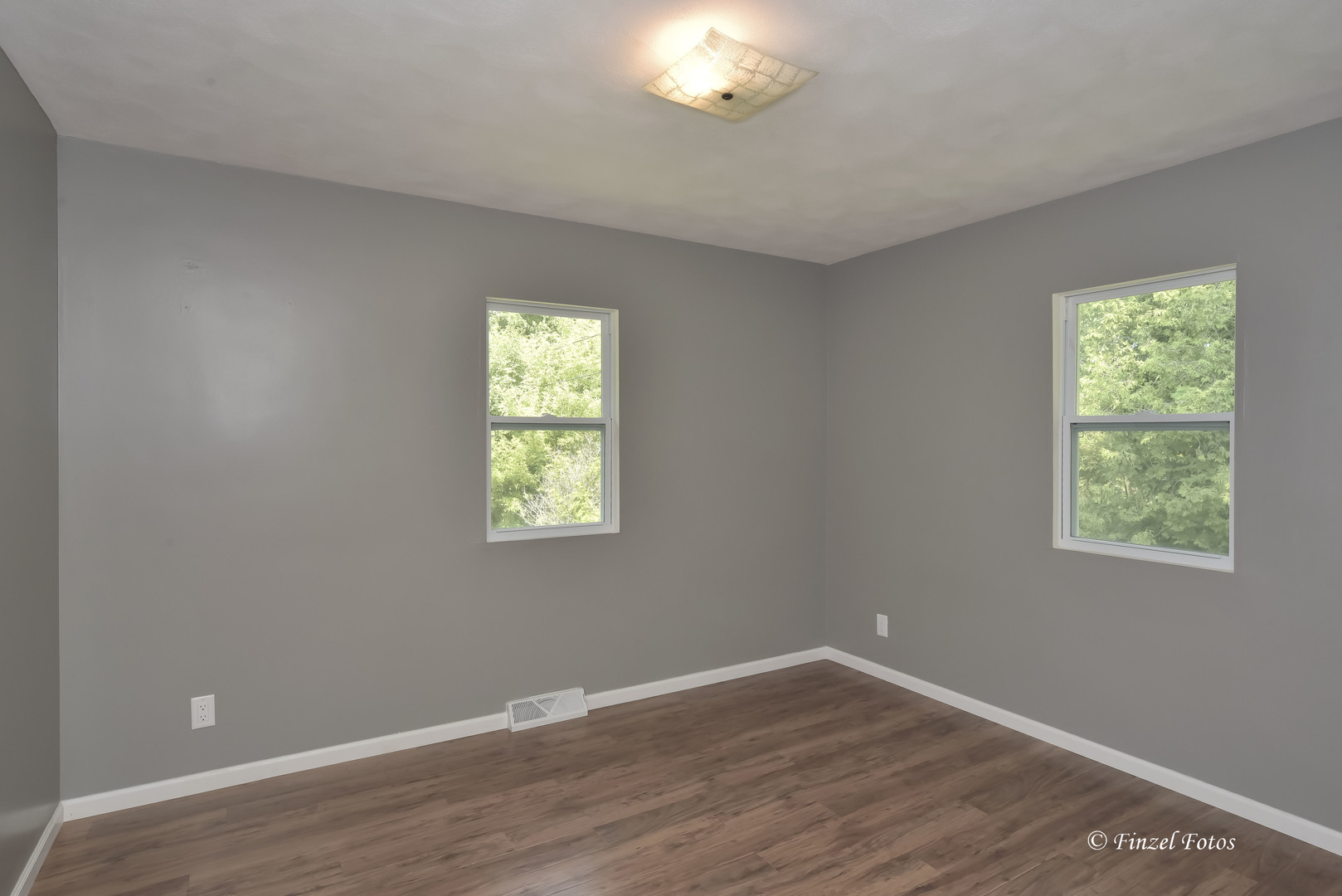 1009 Hickory Road Woodstock, IL 60098 - Photo 10 of 18 a view of an empty room with wooden floor and a window