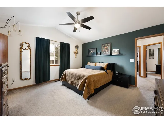 a bed room with a bed and a ceiling fan