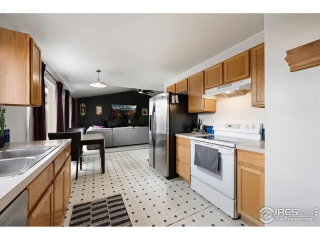 a kitchen with stainless steel appliances kitchen island granite countertop a sink and cabinets