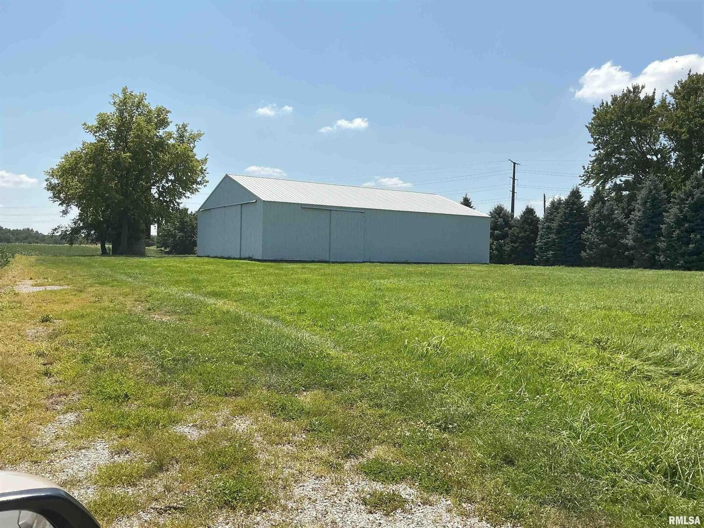 1808 106th Avenue West Milan, IL 61264 - Photo 19 of 19 a view of a green field and trees in the background