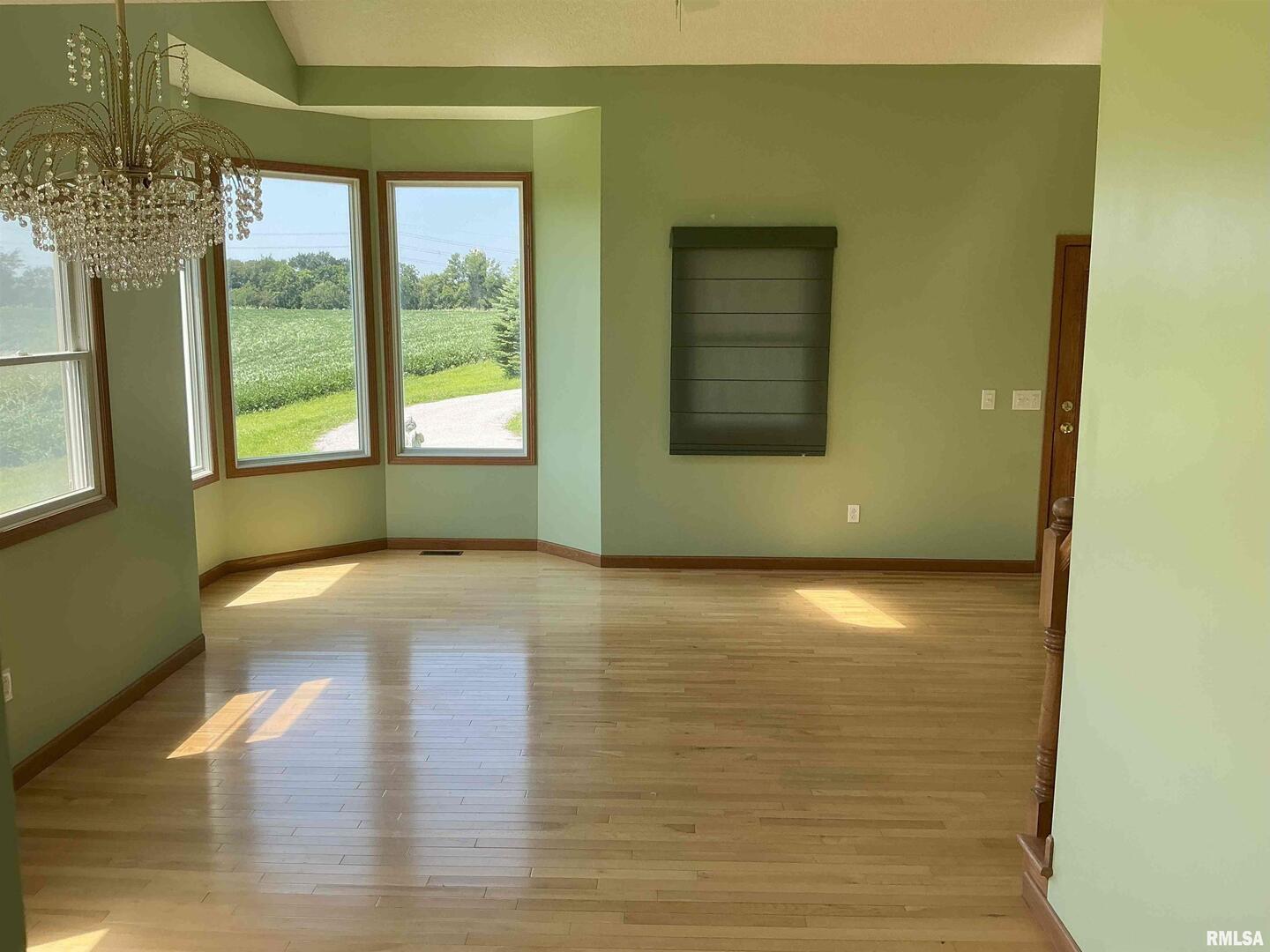 1808 106th Avenue West Milan, IL 61264 - Photo 8 of 19 a view of empty room with wooden floor and fan