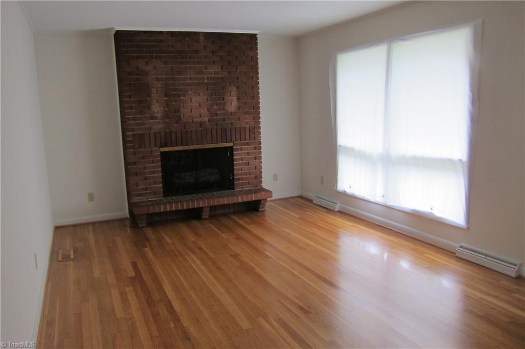 1613 Wolfe Road Greensboro, NC 27405 - Photo 4 of 16 Beautiful Refinished Hardwood Floors...Brick Fireplace with Gas Logs...Lots of Natural Light!