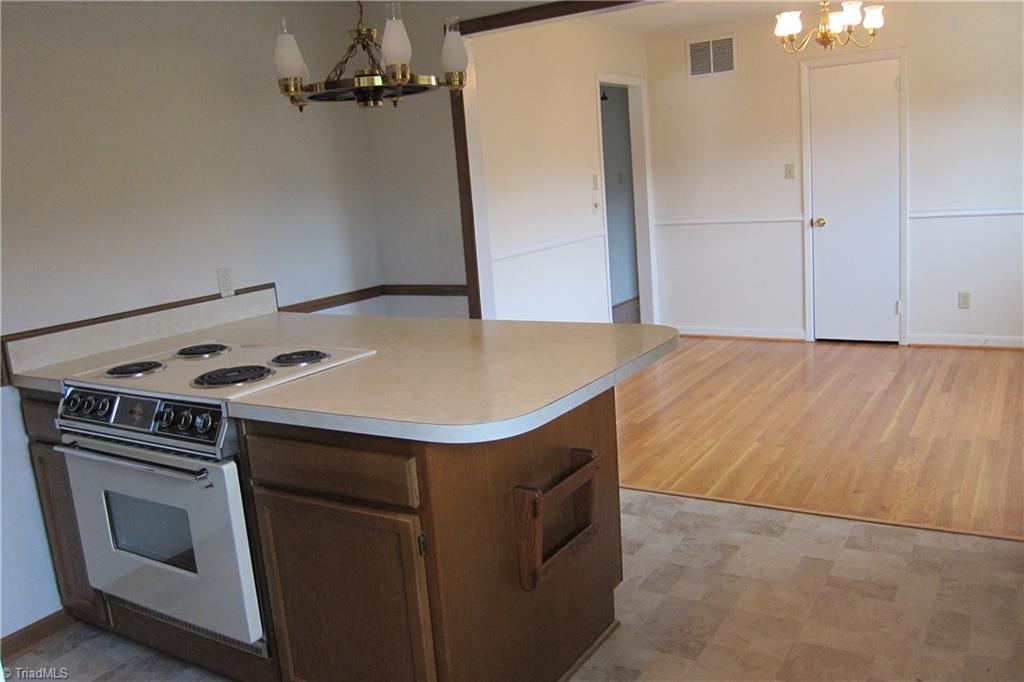 1613 Wolfe Road Greensboro, NC 27405 - Photo 7 of 16 View Of Kitchen...New Vinyl Flooring...Over Looking Dining Room.