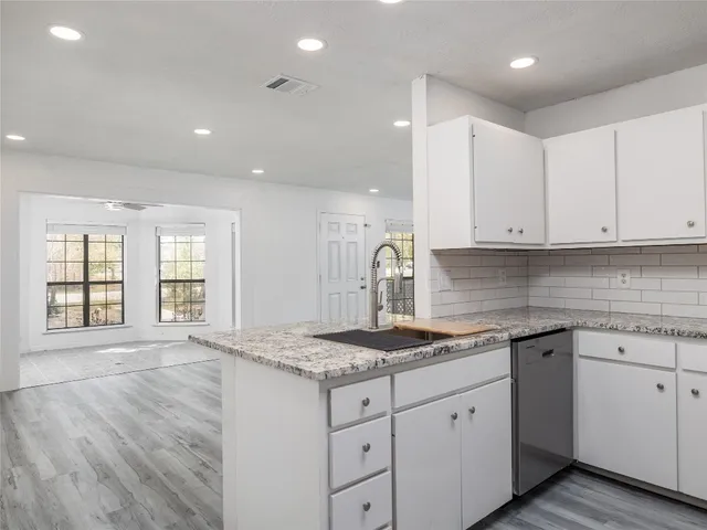 a kitchen with granite countertop white cabinets and a granite counter tops