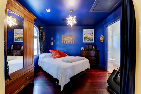 a room with lots of wooden furniture and a window