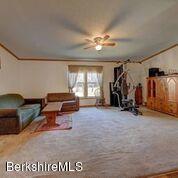 548 Loop Road Savoy, MA 01256 - Photo 2 of 12 a living room with furniture gym equipment and a window