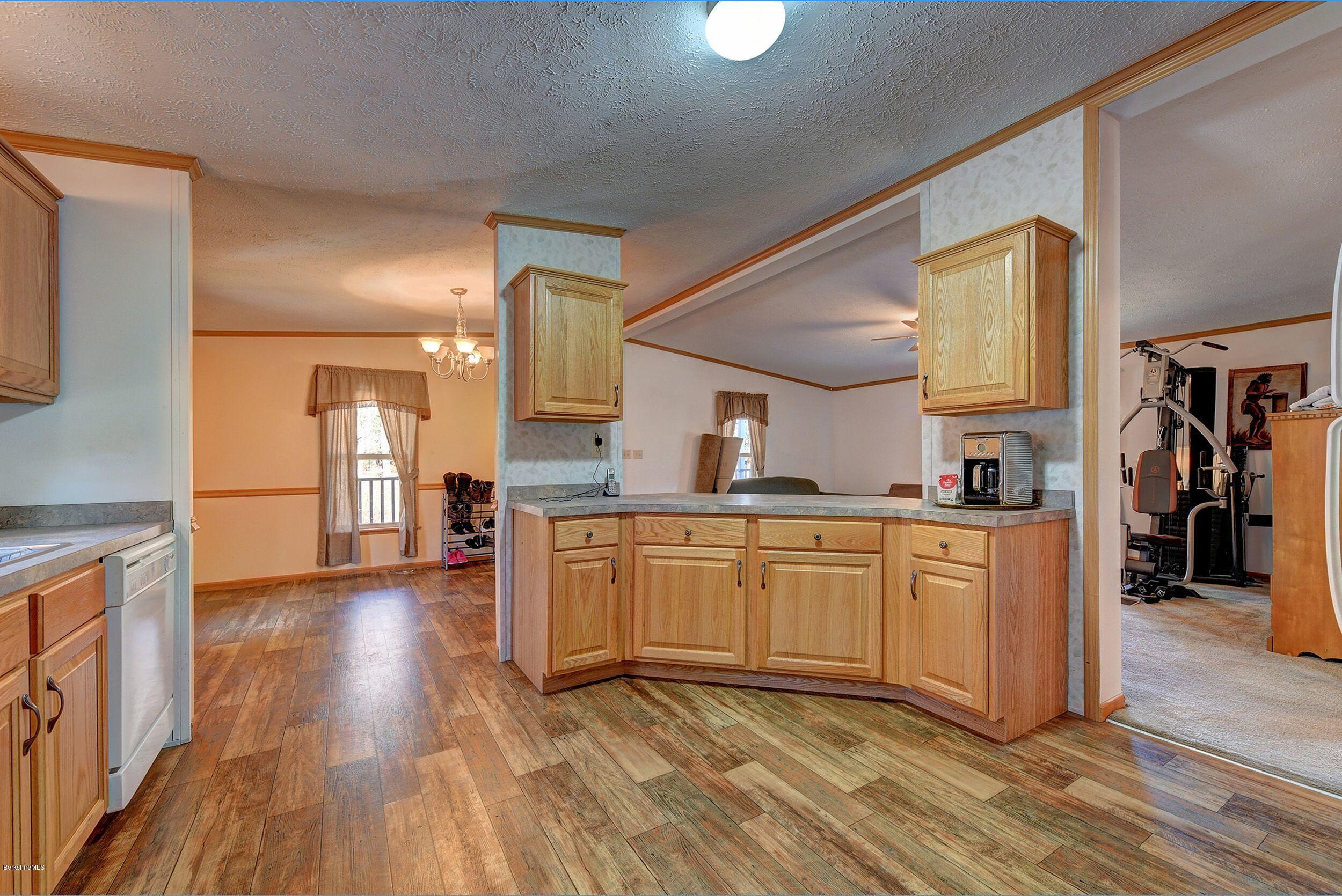 548 Loop Road Savoy, MA 01256 - Photo 5 of 12 a kitchen with stainless steel appliances granite countertop a refrigerator a sink dishwasher and a stove with wooden floor