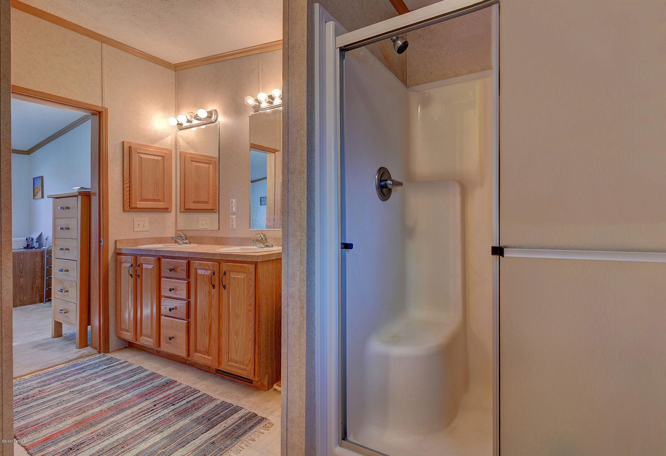 548 Loop Road Savoy, MA 01256 - Photo 7 of 12 a bathroom with a glass shower door and a sink