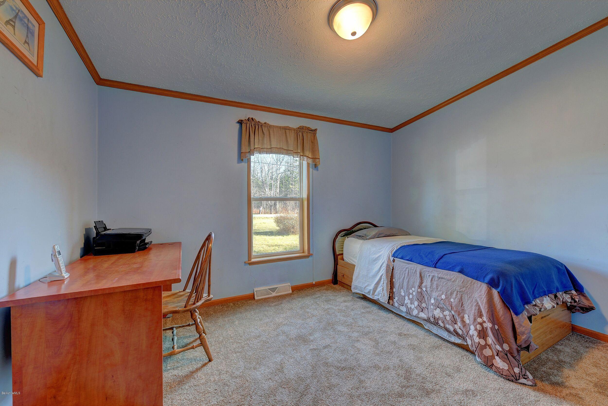 548 Loop Road Savoy, MA 01256 - Photo 8 of 12 a bed sitting in a room next to a window