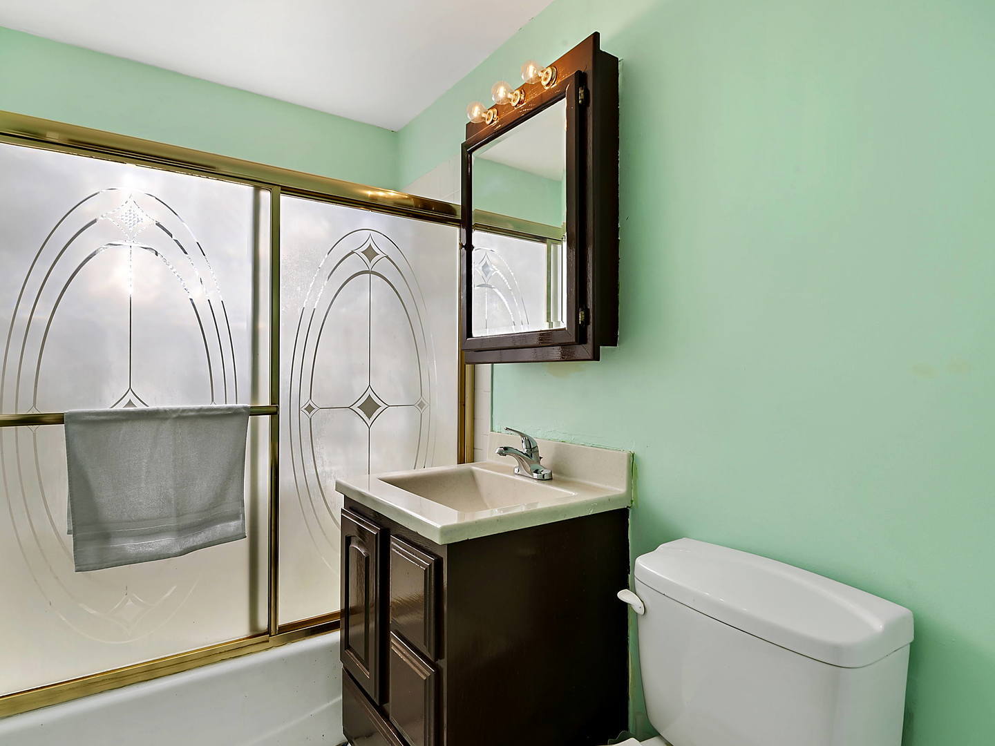 860 Spring Road Elmhurst, IL 60126 - Photo 12 of 17 a bathroom with a toilet sink and mirror