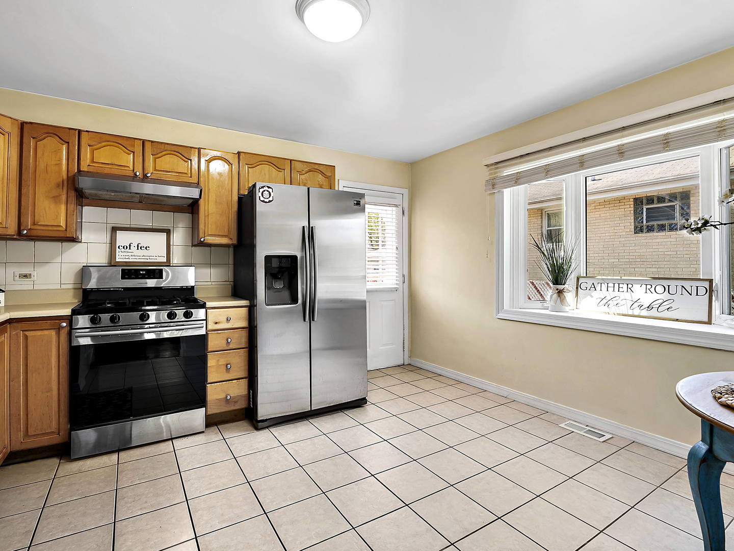 860 Spring Road Elmhurst, IL 60126 - Photo 6 of 17 a kitchen with stainless steel appliances granite countertop a refrigerator and a stove top oven