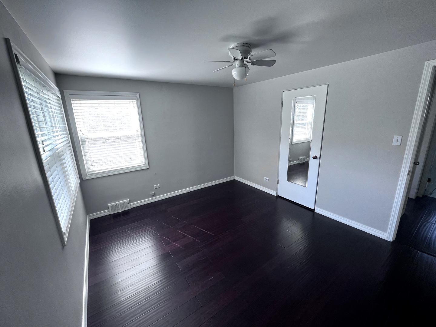 860 Spring Road Elmhurst, IL 60126 - Photo 8 of 17 a view of an empty room with wooden floor and a window