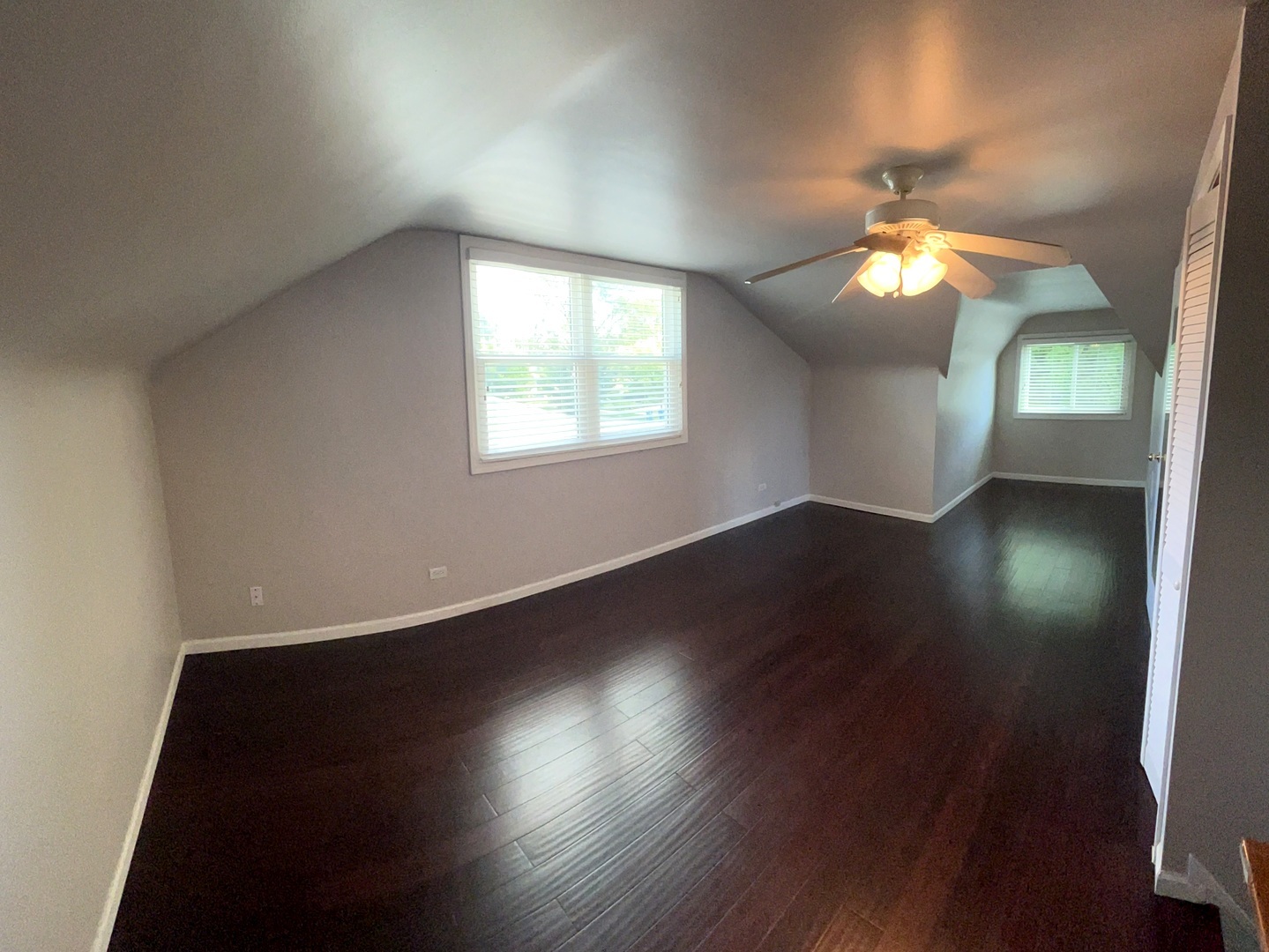 860 Spring Road Elmhurst, IL 60126 - Photo 10 of 17 an empty room with wooden floor chandelier fan and windows