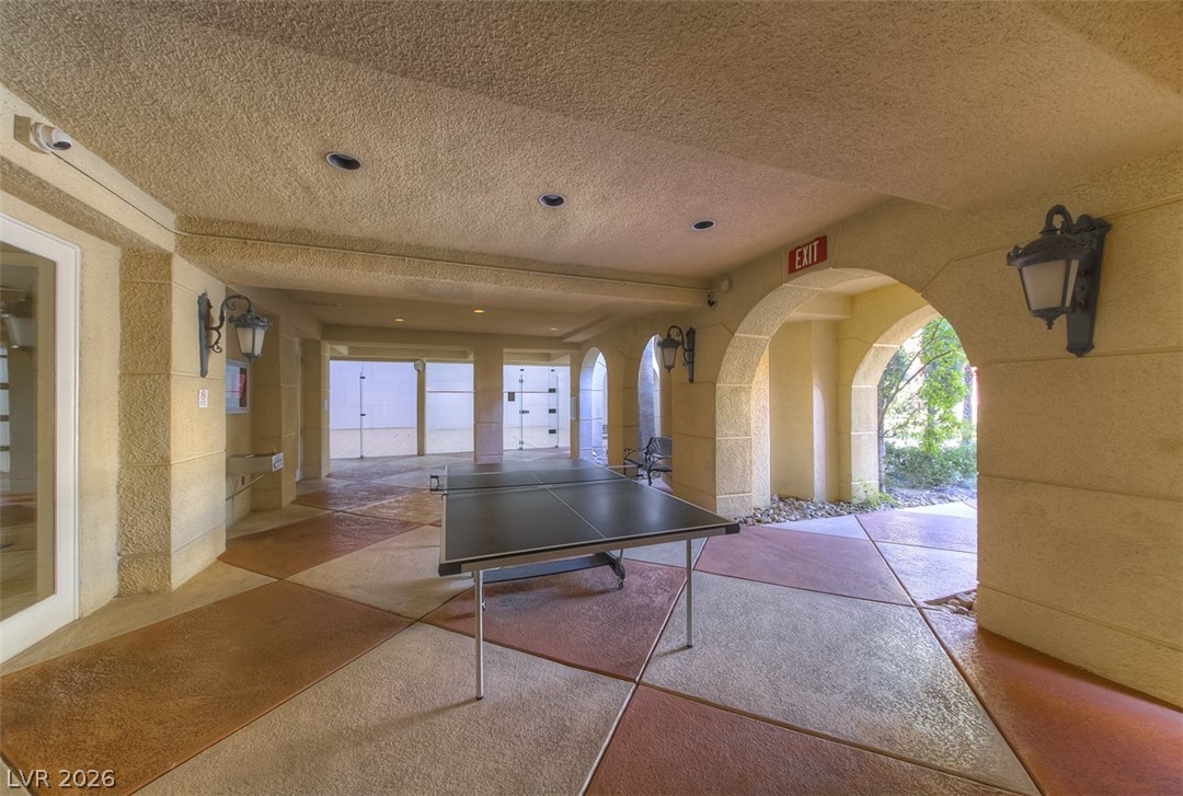 270 East Flamingo Road, Unit 436 Las Vegas, NV 89169 - Photo 16 of 19 An inviting open-air recreation area with a table tennis setup and charming architectural arches.