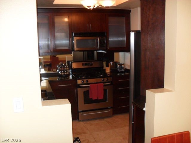 270 East Flamingo Road, Unit 436 Las Vegas, NV 89169 - Photo 4 of 19 This modern kitchen features stainless steel appliances and rich wood cabinetry, perfect for culinary endeavors.