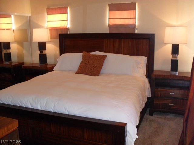 270 East Flamingo Road, Unit 436 Las Vegas, NV 89169 - Photo 5 of 19 This restful bedroom features warm lighting and inviting decor, perfect for unwinding after a long day.