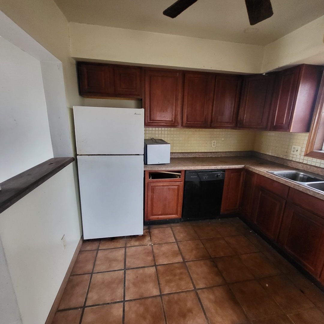6515 East 5000S Road St. Anne, IL 60964 - Photo 4 of 12 a kitchen with a refrigerator a stove top oven a sink and dishwasher