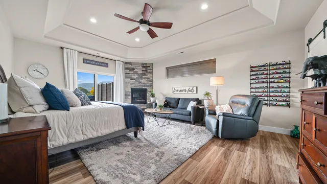 a spacious bedroom with a bed a couch and dresser