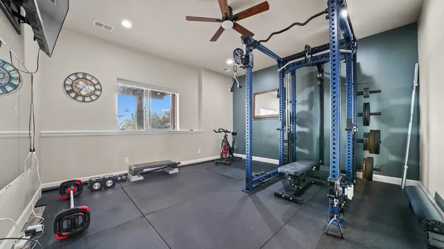 a room with gym equipment and mirror